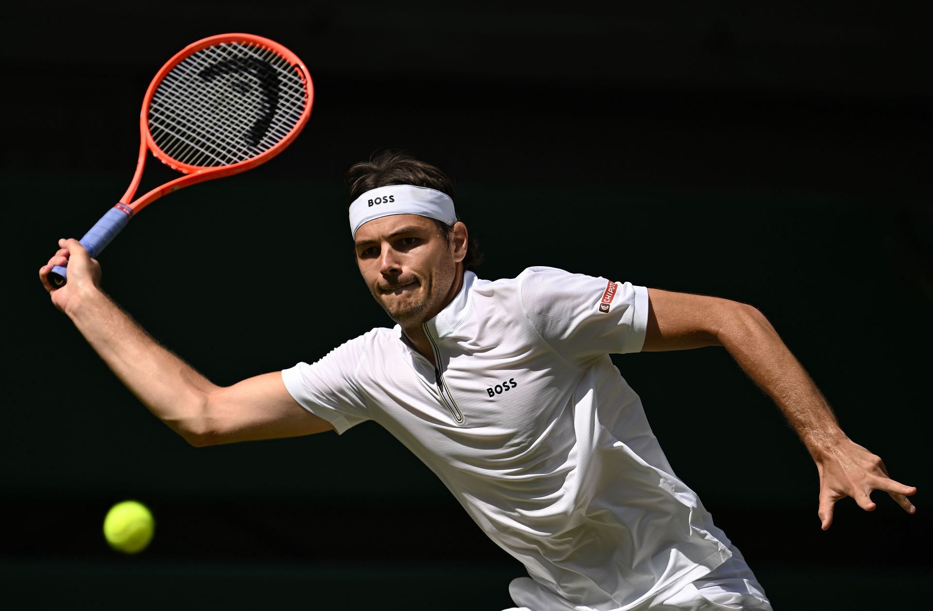 Taylor Fritz tries to retrieve a shot at Wimbledon | Image Source: Getty